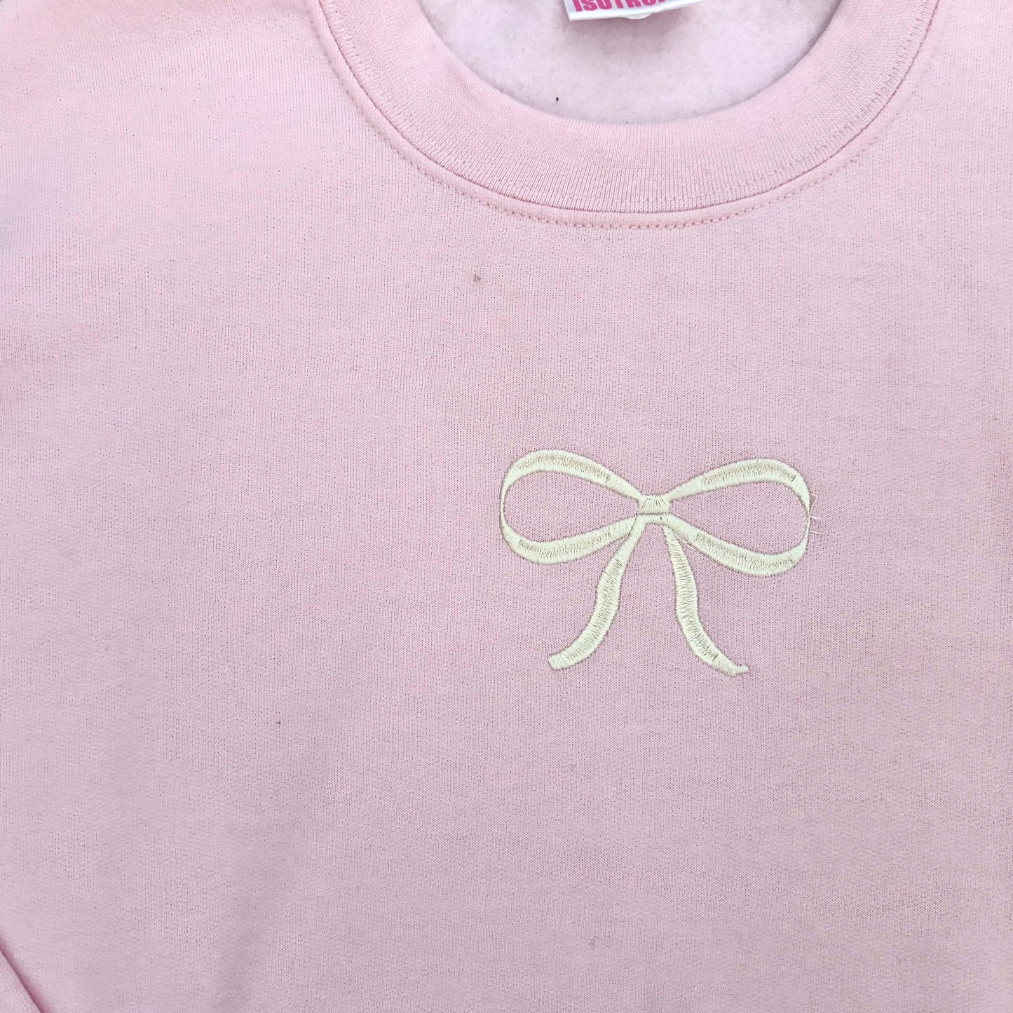 light pink with embroidered bow crewneck